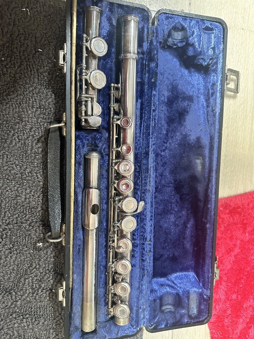 W.T Armstrong silver-plated flute with hard case (Category: Musical Instruments) located in Binan City. Submitted by maydenseven2006 (Listing ID 1468093258, Image 2). Description: - Brand/Model: W.T Armstrong Model 104 silver-plated student flute made in Elkhart, Indiana. - Design: 3-piece disassemblable design with a shiny silver finish - Unique feature: Distinct red pads on several keys - Included: Original hard case with blue velvet lining and