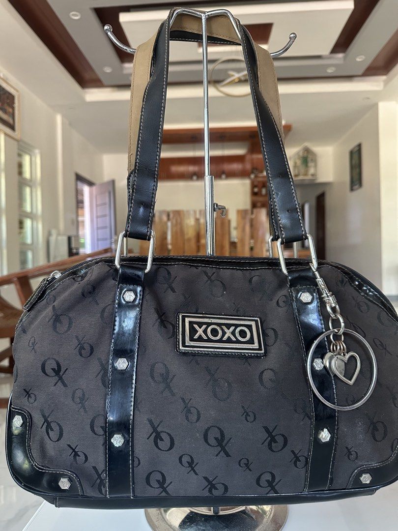 XOXO Black Monogram Shoulder Bag (Category: Shoulder Bags) located in Manila. Submitted by goldenhorse-dafc (Listing ID 1468094405, Image 2). Description: - Brand: XOXO - Color: Black with all-over monogram print - Details: Patent leather trim, silver-tone hardware, and a dangling heart charm on a ring pull - Closure: Secure top zip closure - Interior: Printed fabric lining - Condition: Brand new / Excellent (ready to ship) - Mode of Payment: GCa