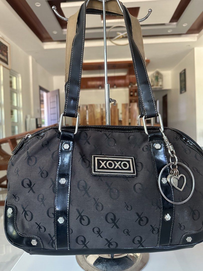 XOXO Black Monogram Shoulder Bag (Category: Shoulder Bags) located in Manila. Submitted by goldenhorse-dafc (Listing ID 1468094405, Image 1). Description: - Brand: XOXO - Color: Black with all-over monogram print - Details: Patent leather trim, silver-tone hardware, and a dangling heart charm on a ring pull - Closure: Secure top zip closure - Interior: Printed fabric lining - Condition: Brand new / Excellent (ready to ship) - Mode of Payment: GCa