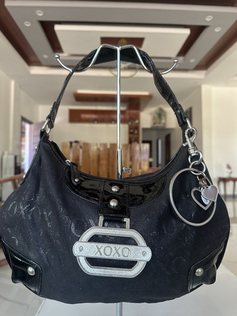 XOXO Black Shimmer Shoulder Bag (Category: Shoulder Bags) located in Manila. Submitted by goldenhorse-dafc (Listing ID 1468094509, Image 1). Description: - Brand: XOXO - Style: Shoulder bag / Handbag - Color/Pattern: Black with all-over sparkly monogram - Details: Patent black trim, glossy handle, and front buckle with XOXO logo - Extras: Includes silver-tone ring keychain with heart charms - Closure: Zipper top - Interior: Patterned lining with 
