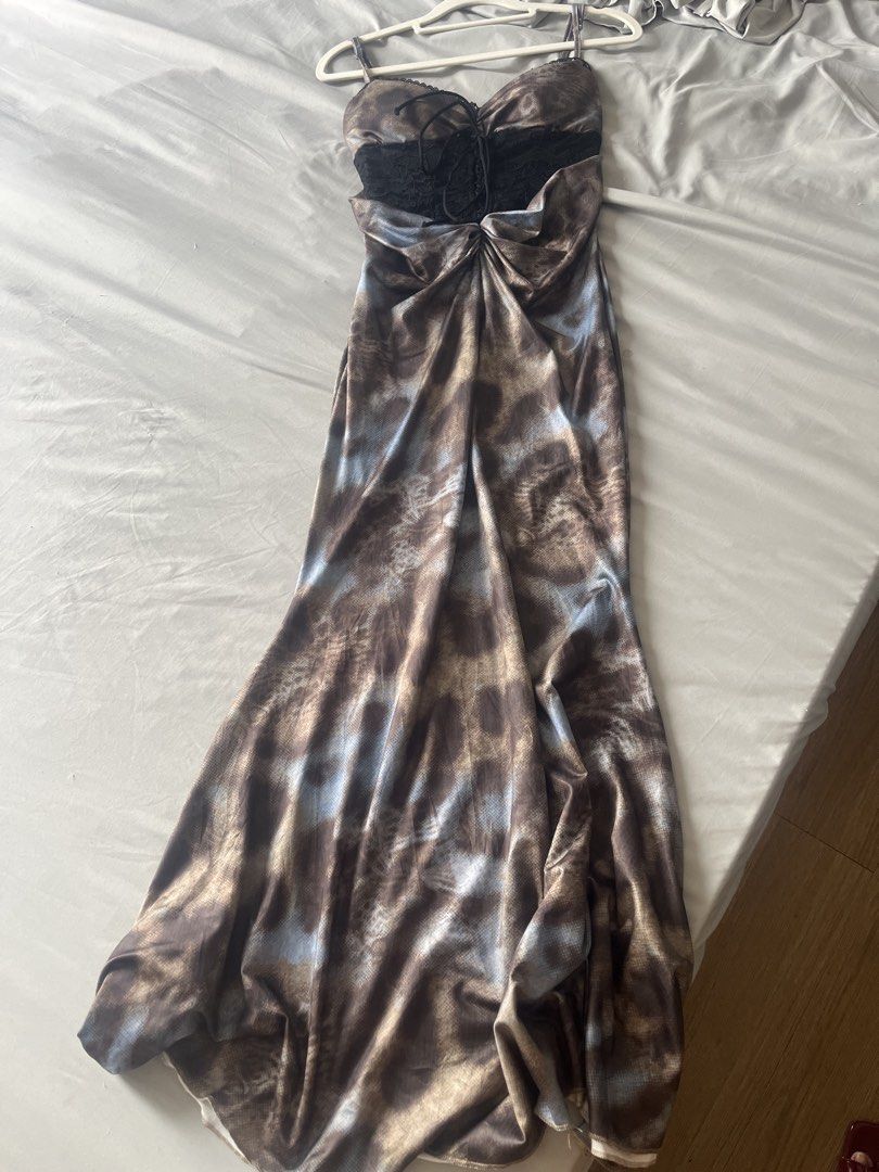 Y2K Leopard Print Cami Maxi Dress (Category: Dresses) located in Manila. Submitted by stacieee (Listing ID 1468112395, Image 3). Description: - XS-Medium Style: Long spaghetti strap maxi dress - Pattern: Brown leopard animal print - Details: Black lace insert panel on chest with lace-up string tie - Fit: Fitted silhouette with a flared hem - Material: Smooth satin-like fabric - Occasion: Ideal for parties, dinners, and night outs - Note: Measurem