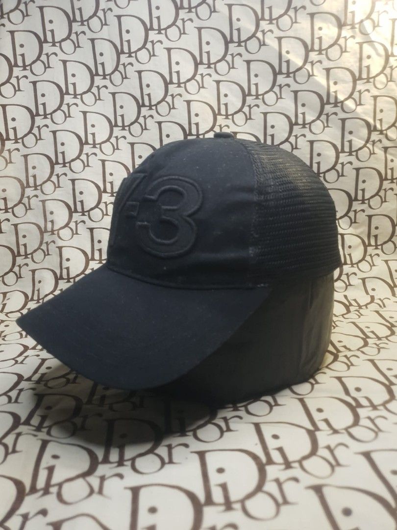 Y-3 BLACK MESH SNAPBACK HAT (Category: Caps & Hats) located in San Fernando. Submitted by _jaximus (Listing ID 1468217785, Image 2). Description: Black Y-3 trucker cap with structured front panels and mesh back. Large tonal Y-3 logo embroidered on the front crown. Adjustable snapback closure in matching black plastic. Interior features white embroidered branding on the inner taping. Curved brim. Breathable mesh construction keeps things cool..