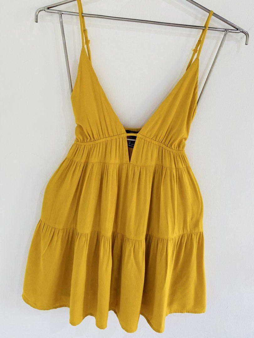 Yellow Cami Mini Dress Size M (Category: Dresses) located in Vigan. Submitted by yourcloset1001 (Listing ID 1468205811, Image 3). Description: - Brand: Forever 21 - Size: Medium - Color: Bright Yellow - Style: V-neck, adjustable spaghetti straps, tiered flare skirt - Fabric: Lightweight (great for warm weather) - Condition: Excellent, worn a few times with no stains or damage.