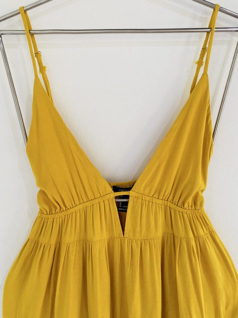 Yellow Cami Mini Dress Size M (Category: Dresses) located in Vigan. Submitted by yourcloset1001 (Listing ID 1468205811, Image 2). Description: - Brand: Forever 21 - Size: Medium - Color: Bright Yellow - Style: V-neck, adjustable spaghetti straps, tiered flare skirt - Fabric: Lightweight (great for warm weather) - Condition: Excellent, worn a few times with no stains or damage.