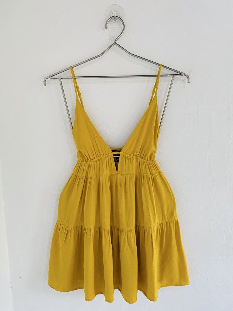 Yellow Cami Mini Dress Size M (Category: Dresses) located in Vigan. Submitted by yourcloset1001 (Listing ID 1468205811, Image 1). Description: - Brand: Forever 21 - Size: Medium - Color: Bright Yellow - Style: V-neck, adjustable spaghetti straps, tiered flare skirt - Fabric: Lightweight (great for warm weather) - Condition: Excellent, worn a few times with no stains or damage.