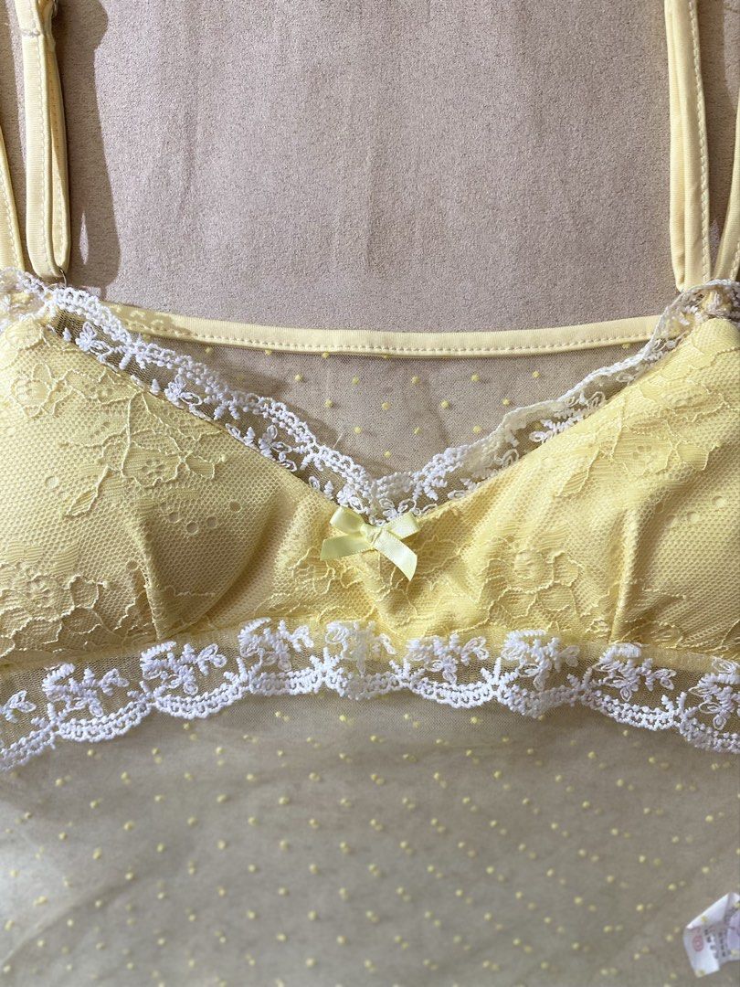 Yellow Lace Trim Dot Mesh Cami Top (Category: Sleeveless) located in Quezon City. Submitted by rosealison (Listing ID 1468127133, Image 3). Description: - Color: Butter yellow with white lace trim Size: Small - Design: Sheer mesh body with tiny polka dots and a cute center bow - Features: Adjustable spaghetti straps, unpadded soft cups - Condition: used twice with tag attached - Lightweight and sheer fabric.