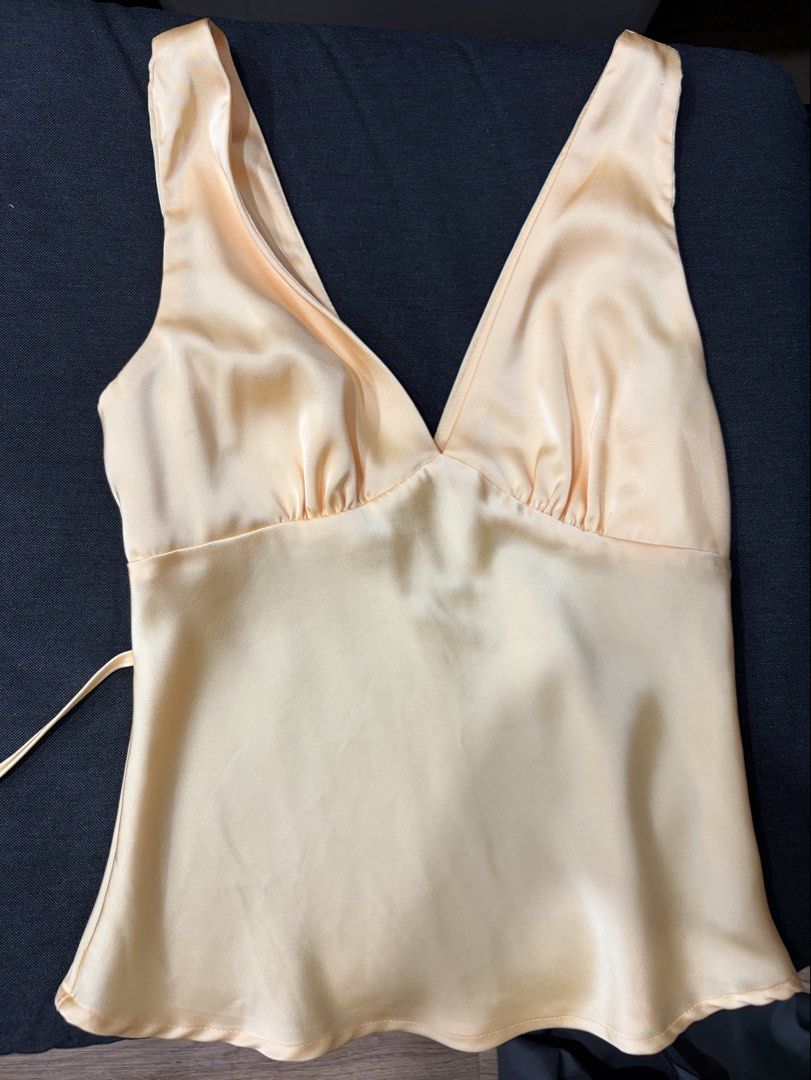 Yellow Satin V-Neck Sleeveless Top (Category: Sleeveless) located in Manila. Submitted by cpaa.aaa (Listing ID 1468138322, Image 1). Description: Satin Yellow Adjustable tie string detail at the back Size: XS-S.