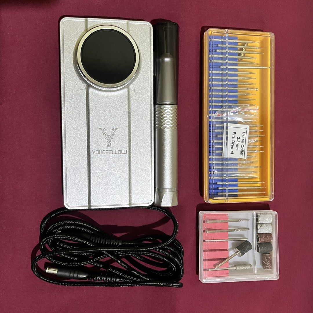 Yokefellow Professional Electric Nail Drill Machine Set (Category: Hands & Nails) located in Davao. Submitted by shopbluese (Listing ID 1468071860, Image 1). Description: - Brand/Model: Yokefellow Electric Nail Drill - Color/Design: Silver control unit with smooth rotary dial speed control - Included: Handpiece and power cable - Accessories: Large storage case of drill bits with 2.3mm brass collets - Extras: Smaller accessory box with sanding ban