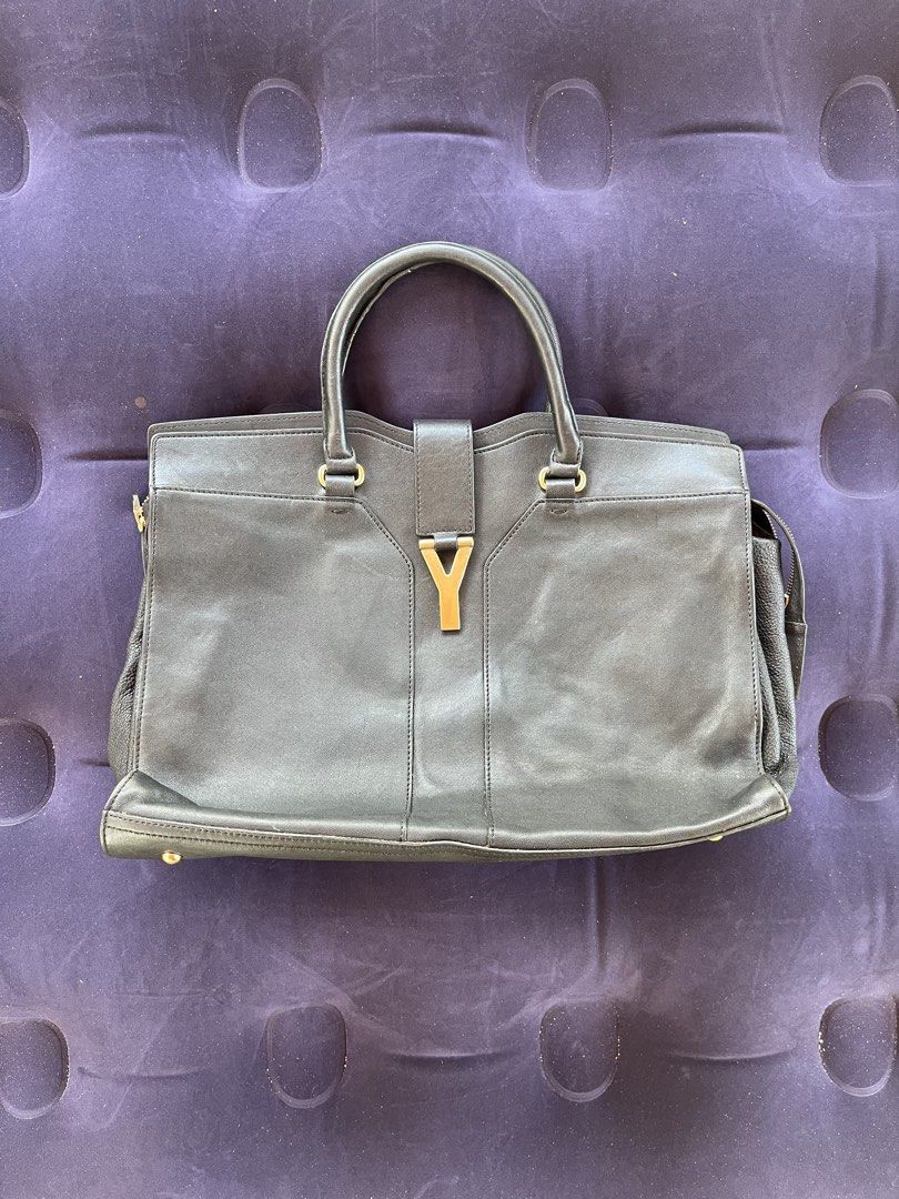 Yves Saint Laurent Y Cabas Tote Handbag Authentic (Category: Tote Bags) located in Tacloban City. Submitted by luxbag_phhh (Listing ID 1468084562, Image 1). Description: Authentic Yves Saint Laurent (YSL) - Material: Premium black leather - Hardware: Gold-tone accents with signature Y front strap closure and protective metal feet - Handles: Double top handles for comfortable carrying - Compartments: Secure zipped side compartments and a clean int