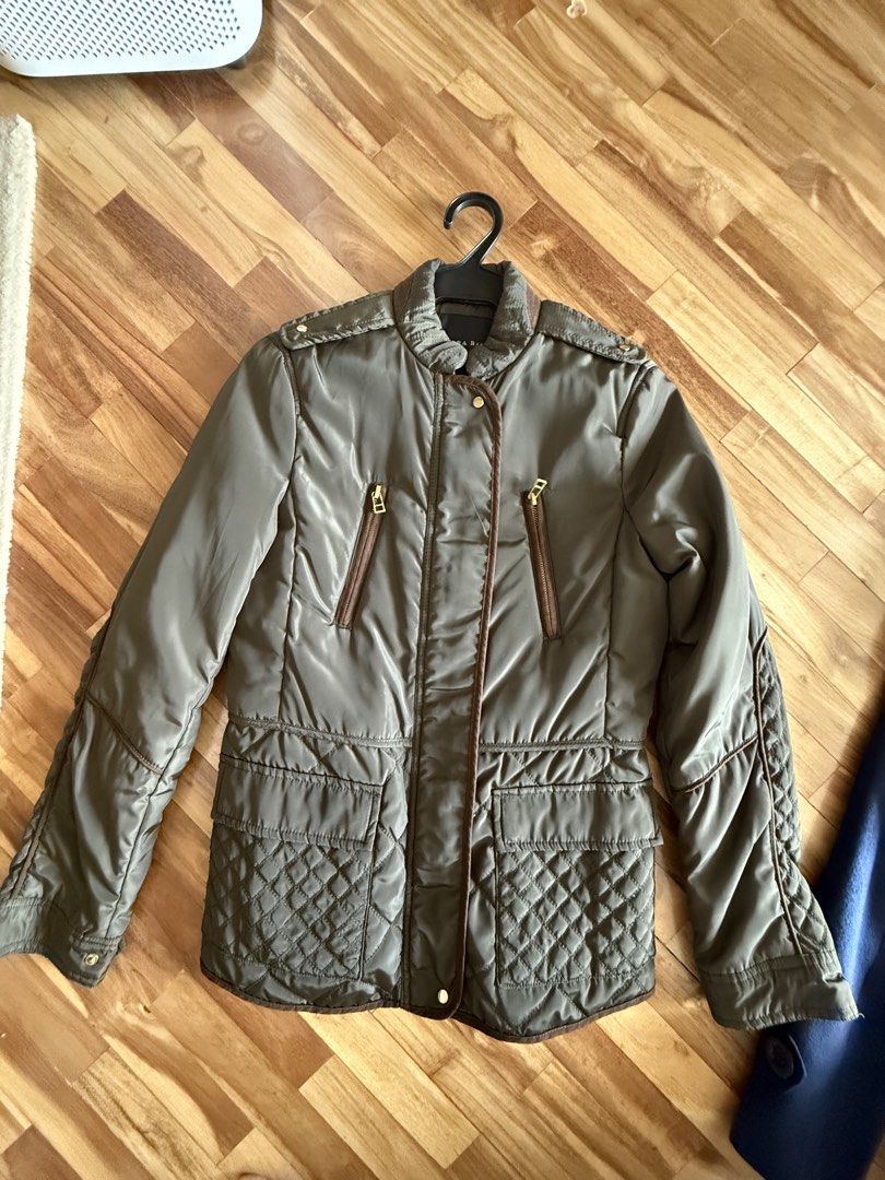 Zara Basic Olive Green Quilted Jacket (Category: Coats, Jackets and Outerwear) located in Makati City. Submitted by rockandraw (Listing ID 1468066139, Image 1). Description: - Brand/Model: Zara Basic Olive Green Quilted Jacket - Hardware: Elegant gold-tone hardware with front zip pockets and button details - Accents: Stylish brown piping along the collar and front placket - Design: Quilted lower half and sleeve details with a standard fit - Condi