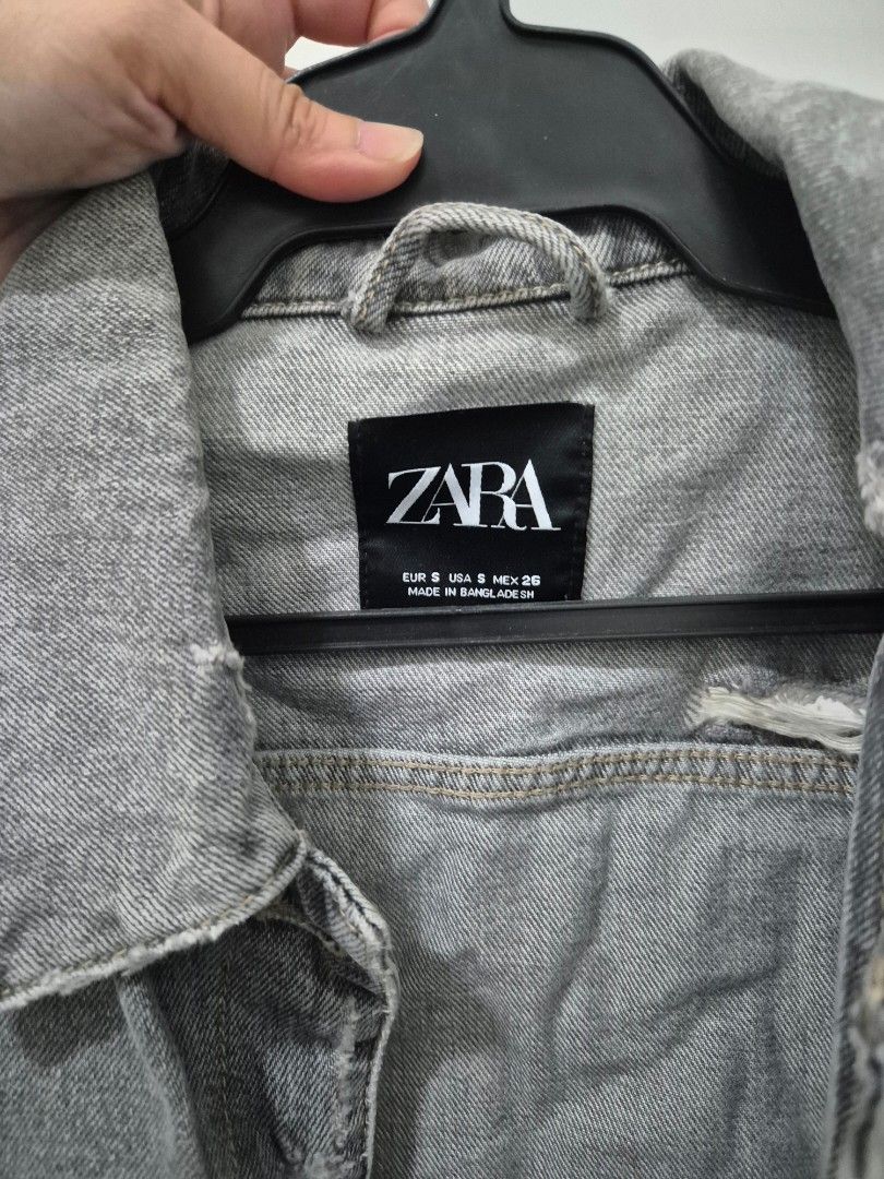 Zara Grey Distressed Crop Denim Jacket Size S (Category: Coats, Jackets and Outerwear) located in Quezon City. Submitted by 53888 (Listing ID 1468200090, Image 2). Description: - Brand: Zara - Color: Grey - Size: S (fits true to size) - Fit: Cropped with raw frayed hem - Details: Distressed accents near collar and shoulder - Features: Front button closure and chest pockets - Origin: Made in Bangladesh.