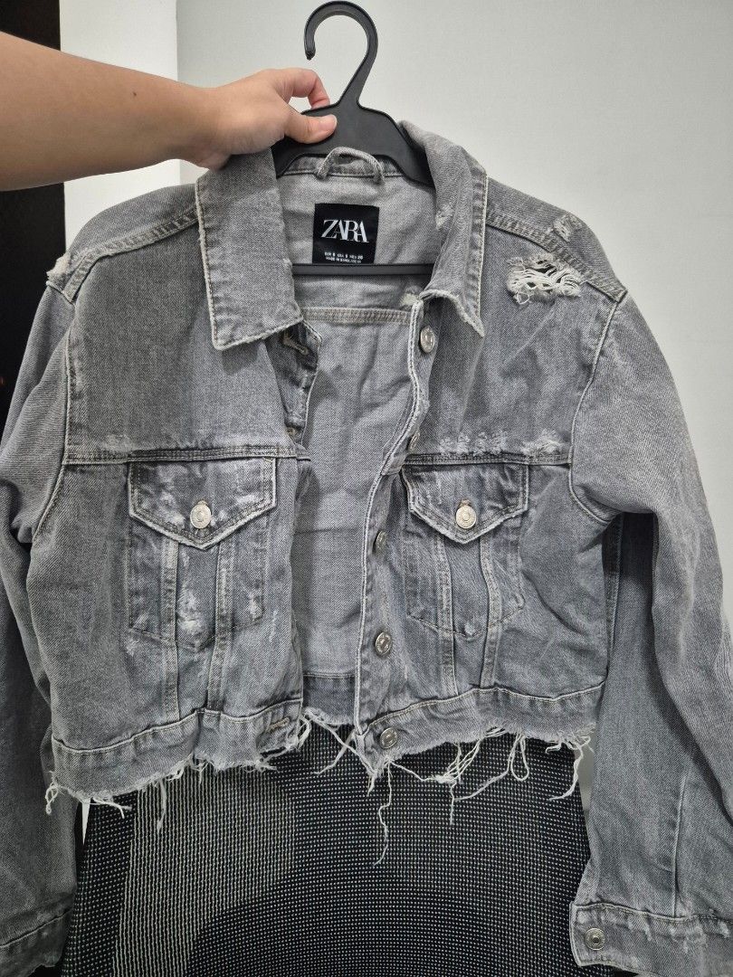 Zara Grey Distressed Crop Denim Jacket Size S (Category: Coats, Jackets and Outerwear) located in Quezon City. Submitted by 53888 (Listing ID 1468200090, Image 1). Description: - Brand: Zara - Color: Grey - Size: S (fits true to size) - Fit: Cropped with raw frayed hem - Details: Distressed accents near collar and shoulder - Features: Front button closure and chest pockets - Origin: Made in Bangladesh.