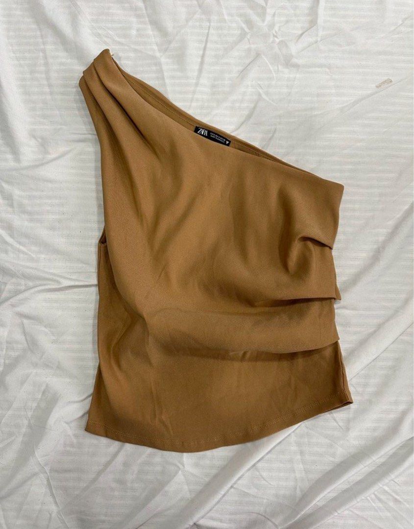 [Zara] One-Shoulder Draped Top (Category: Others Tops) located in Muntinlupa City. Submitted by shopblank (Listing ID 1468182617, Image 1). Description: - Brand: Zara - Style: One-shoulder top with front draping - Color: Rich caramel brown - Material: Smooth and stretchy for a flattering body-hugging fit - Condition: Clean, smoke-free home.