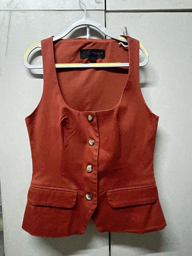 Zara Terracotta Vest (Category: Sleeveless) located in Quezon City. Submitted by prebyv (Listing ID 1468232133, Image 2). Description: Used twice only - Size: EUR/USA XS (MEX 24) - Color: Rich rust orange - Design: Scoop neckline, tailored silhouette, and back panel detailing - Closure & Pockets: Front four-button closure with two functional flap pockets - Origin: Made in Turkey.