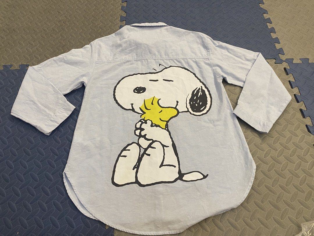 Zara x Peanuts Snoopy Long Sleeve Button Down Shirt (Category: Longsleeves) located in Santa Rosa. Submitted by hoardqueensdeclutter (Listing ID 1468198270, Image 1). Description: - Brand: Zara (Peanuts Collection) - Item: Light blue long sleeve button-down shirt - Design: Snoopy 'GOOD TIMES FOREVER' chest pocket graphic and huge Snoopy back print - Features: Standard collar, button cuffs, and curved hemline - Size: 13-14 years / 164 cm - Conditi