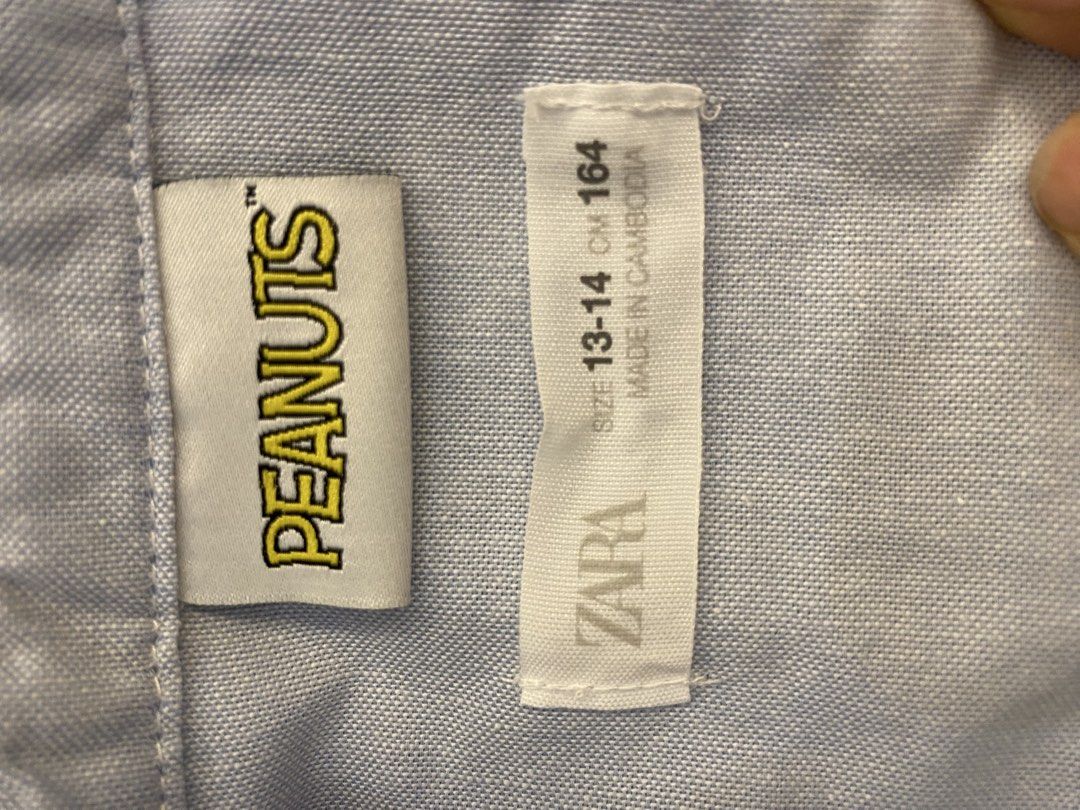 Zara x Peanuts Snoopy Long Sleeve Button Down Shirt (Category: Longsleeves) located in Santa Rosa. Submitted by hoardqueensdeclutter (Listing ID 1468198270, Image 3). Description: - Brand: Zara (Peanuts Collection) - Item: Light blue long sleeve button-down shirt - Design: Snoopy 'GOOD TIMES FOREVER' chest pocket graphic and huge Snoopy back print - Features: Standard collar, button cuffs, and curved hemline - Size: 13-14 years / 164 cm - Conditi