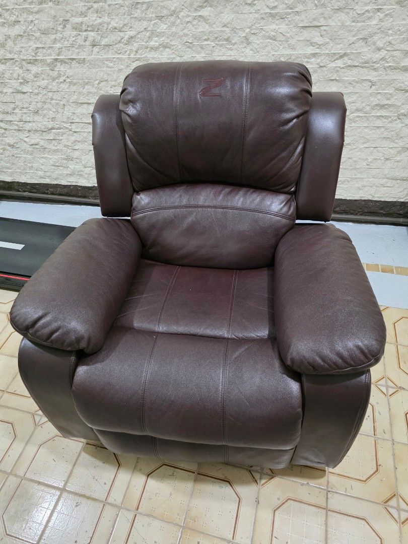 Zion Reclining Chair (Category: Chairs) located in Quezon City. Submitted by allaboutyoused (Listing ID 1468180363, Image 1). Description: Zion Reclining Chair: Dark brown leather - Ideal for: Living room or study - Comfort: Extra-thick cushioning on the backrest and armrests - Function: Sturdy build with a smooth manual recline mechanism - Condition: Shows some wear and scuffing on the top corner edges of the backrest as shown in photos - No iss