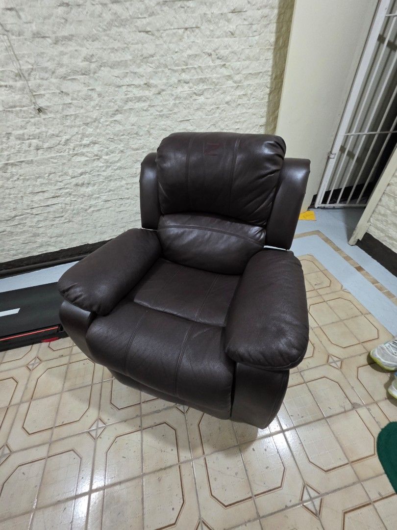 Zion Reclining Chair (Category: Chairs) located in Quezon City. Submitted by allaboutyoused (Listing ID 1468180363, Image 2). Description: Zion Reclining Chair: Dark brown leather - Ideal for: Living room or study - Comfort: Extra-thick cushioning on the backrest and armrests - Function: Sturdy build with a smooth manual recline mechanism - Condition: Shows some wear and scuffing on the top corner edges of the backrest as shown in photos - No iss