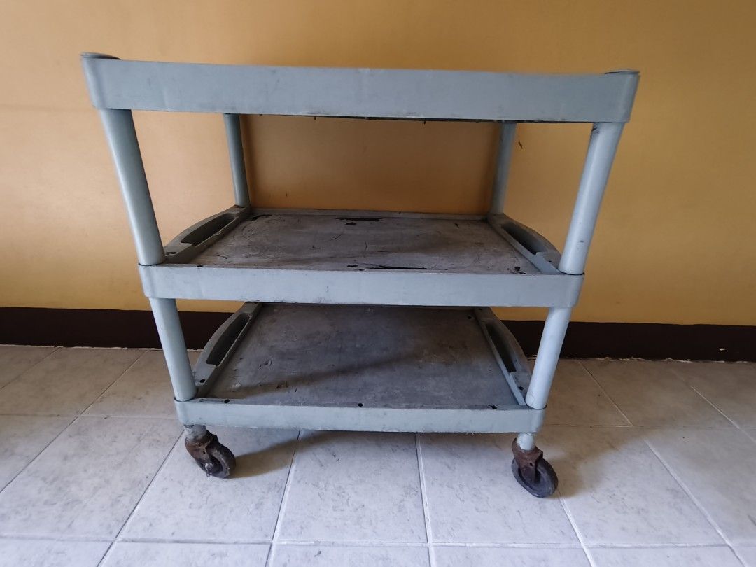 3-Tier Plastic Utility Cart with Wheels (Category: Storage Boxes & Baskets) located in Pasig City. Submitted by maming73 (Listing ID 1468305966, Image 1). Description: - Color: Grey - Material: Heavy-duty plastic with metal caster hardware - Design: 3 levels of storage with built-in top handles - Mobility: 4 smooth-rolling caster wheels for easy movement - Condition: Shows normal daily wear including surface scratches, scuffs, and visible rust on