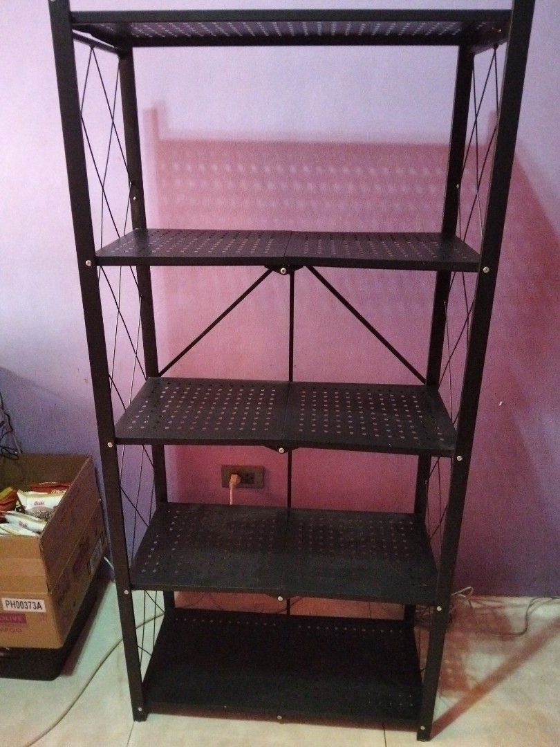 5-Tier Foldable Heavy Duty Storage Rack Black (Category: Shelves, Cabinets & Racks) located in Marikina City. Submitted by rareocean_9df934 (Listing ID 1468395237, Image 1). Description: - Color & Material: Black heavy-duty metal construction - Storage: 5 spacious, perforated shelves - Setup: 100% foldable with zero installation needed - Stability: Sturdy frame featuring X-cross bars on sides and back - Dimensions: 162cm (Height) x 71cm (Length) 