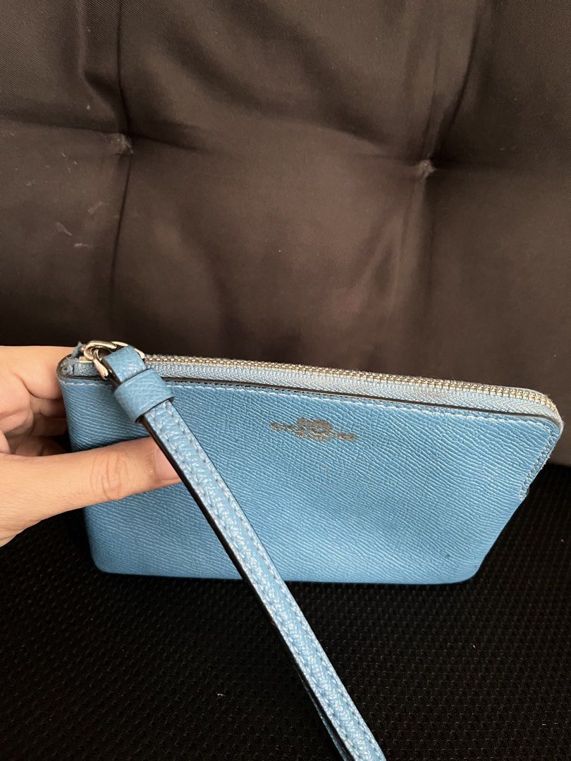 🇺🇸 Authentic Coach Blue Leather Wristlet (Category: Luxury Bags & Wallets) located in Manila. Submitted by prelovedpick.com (Listing ID 1468313853, Image 3). Description: Decluttering ‼️ With freebies - Brand: Coach - Material: Crossgrain leather in bright blue - Hardware: Silver-tone with secure zip closure - Features: Attached matching wrist strap, interior fabric lining with a slip pocket - Authenticity: Interior creed tag with serial number