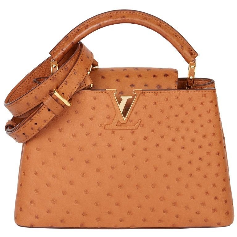 💢 Louis Vuitton Tan Ostrich Leather Capucines BB (Category: Luxury Bags & Wallets) located in Kibawe. Submitted by yumicaspia39544 (Listing ID 1468311571, Image 1). Description: Louis Vuitton Tan Ostrich Leather Capucines BB 13,999p plus sf Genuine Ostrich leather Like new/Brandnew By Nicolas Ghesquière Brown Ostrich Brass Hardware Rolled Handle & Single Adjustable Shoulder Strap Leather Lining & Single Interior Pocket Fold-In Flap Closure at To