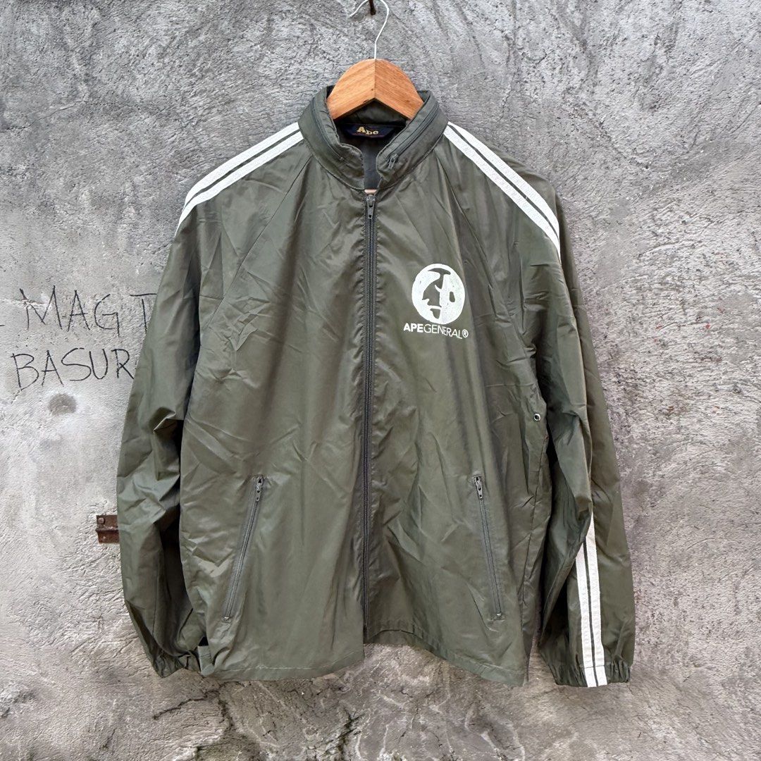 A Bathing Ape Ape General Track Jacket Olive (Category: Coats, Jackets and Outerwear) located in Caloocan City. Submitted by ayogorenia1002 (Listing ID 1468351398, Image 1). Description: - Brand: A Bathing Ape (BAPE) - Color: Olive green with white double sleeve stripes - Details: Full zip, high collar with unique zipper accent, Ape General chest logo - Pockets: Two zippered side pockets - Condition: Excellent / Pre-owned - Shipping: Fast ship na