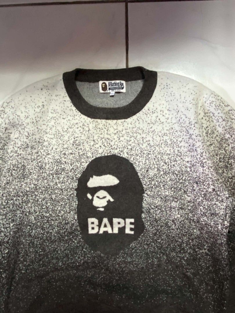 A Bathing Ape Bape Gradient Camo Ape Head Sweater (Category: Coats, Jackets and Outerwear) located in Angeles City. Submitted by pkthreadz (Listing ID 1468305000, Image 2). Description: - Brand: A Bathing Ape (Bape) - Item: Heavyweight knit sweater - Color/Design: Black and white gradient speckle wash with iconic ape head logo and text branding - Details: Dark charcoal ribbed collar, cuffs, and hem, includes classic neck, size, and sleeve tags - 