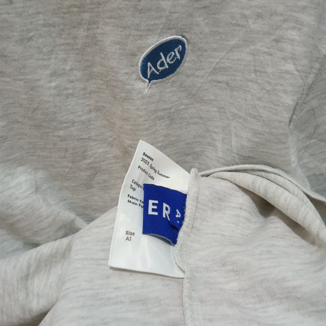 ADER ERROR Multiple Embroid Design Shirt (Category: Tshirts & Polo Shirts ) located in Caloocan City. Submitted by jaychingsss (Listing ID 1468399028, Image 3). Description: Ader Error Shirt - 250 21x26 Complete Tags Heather Gray No issue NEED WASH.