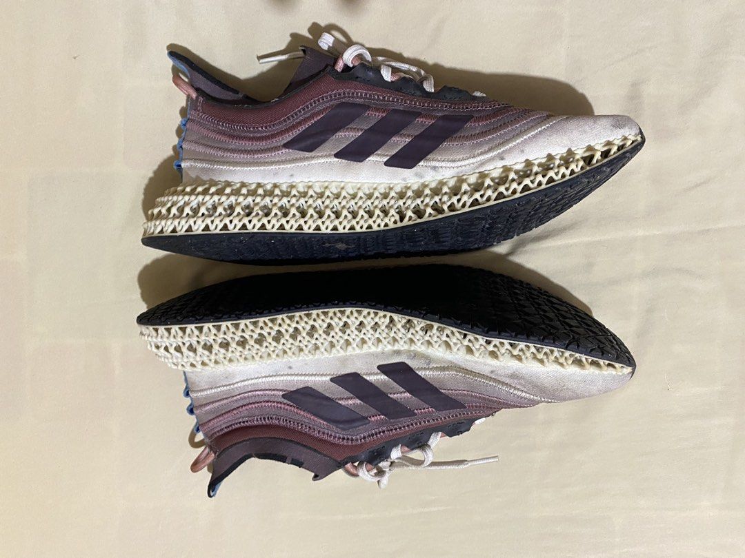 Adidas 4D Runner Sneakers (Category: Sneakers) located in Polangui. Submitted by thrift2house (Listing ID 1468365712, Image 3). Description: - Brand: Adidas - Model: Adidas 4D - Colorway: Mauve, white, and blue inner lining - Upper: Made with Parley recycled materials - Sole: Futuristic lattice midsole with black rubber outsole - Condition: Pre-owned with dirt marks on midsoles and regular wear on outsoles - Inclusions: Comes with white laces.
