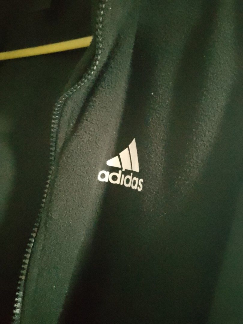 Adidas Black Fleece Zip-Up Jacket (Category: Coats, Jackets and Outerwear) located in Manila. Submitted by warmtiger.a2c491 (Listing ID 1468361228, Image 2). Description: - Brand: Adidas - Color: Black with white embroidered logo - Material: Warm and cozy fleece - Features: Full zip front, high collar, and adjustable drawstring hem with toggles - Condition: Excellent - Perfect for: Cool weather layering and casual wear - Shipping or meetups avail