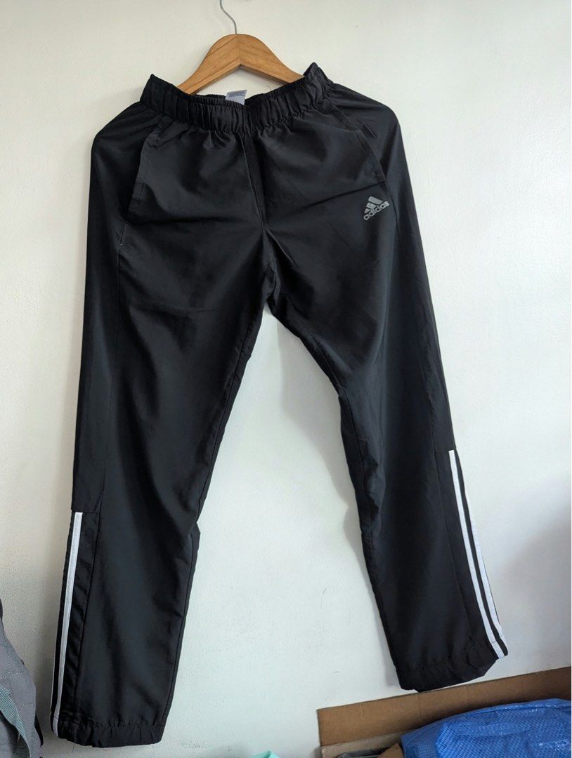 Adidas Black Track Pants with White Stripes (Category: Joggers) located in Quezon City. Submitted by thegoodkarmaph (Listing ID 1468325278, Image 1). Description: - Color: Classic Black with signature white three stripes - Material: Lightweight, breathable nylon/polyester blend - Features: Comfortable elastic waistband, convenient side pockets, and small silver Adidas logo - Versatility: Perfect for gym workouts, running, or casual everyday wear 