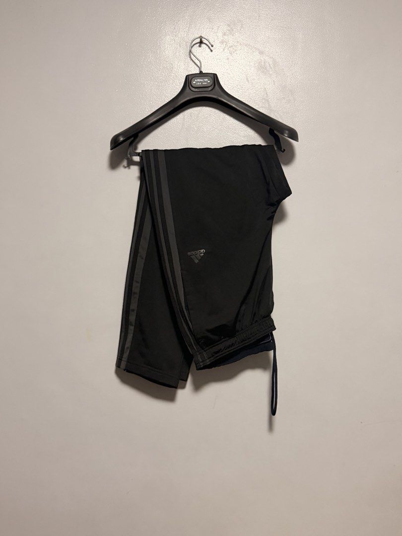 Adidas Black Track Pants with Grey Stripes (Category: Activewear) located in Manila. Submitted by swiftgem.eeb06e (Listing ID 1468390234, Image 1). Description: - Authentic Black Adidas track pants - Classic three stripes on the sides with iconic Adidas logo near the pocket - Elastic waistband with adjustable drawstring for a secure fit - Lightweight material, perfect for workouts or casual lounging - Straight leg fit with clean hems - Condition: