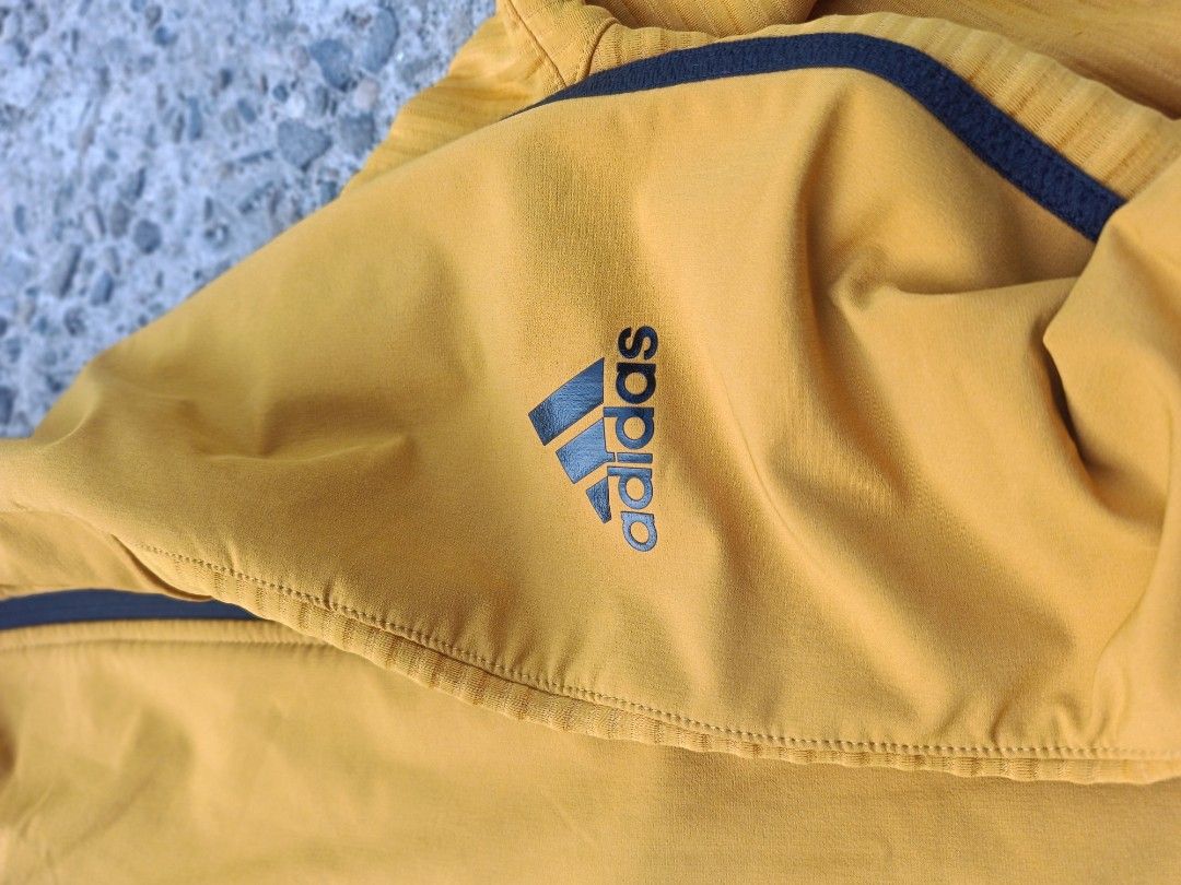 Adidas cold.rdy Yellow Hooded Jacket (Category: Activewear) located in Urdaneta. Submitted by tetsudoubletaps (Listing ID 1468497408, Image 3). Description: + SF 23 x 27 - 28 Premium na premium isuot. - Brand/Model: Adidas Cold.Rdy hooded jacket - Color: Bright yellow with black contrast design - Closures: Premium YKK double zippers on front - Pockets: Extra zipped chest pocket on the left side - Material: Textured ribbed fabric panels down sleev
