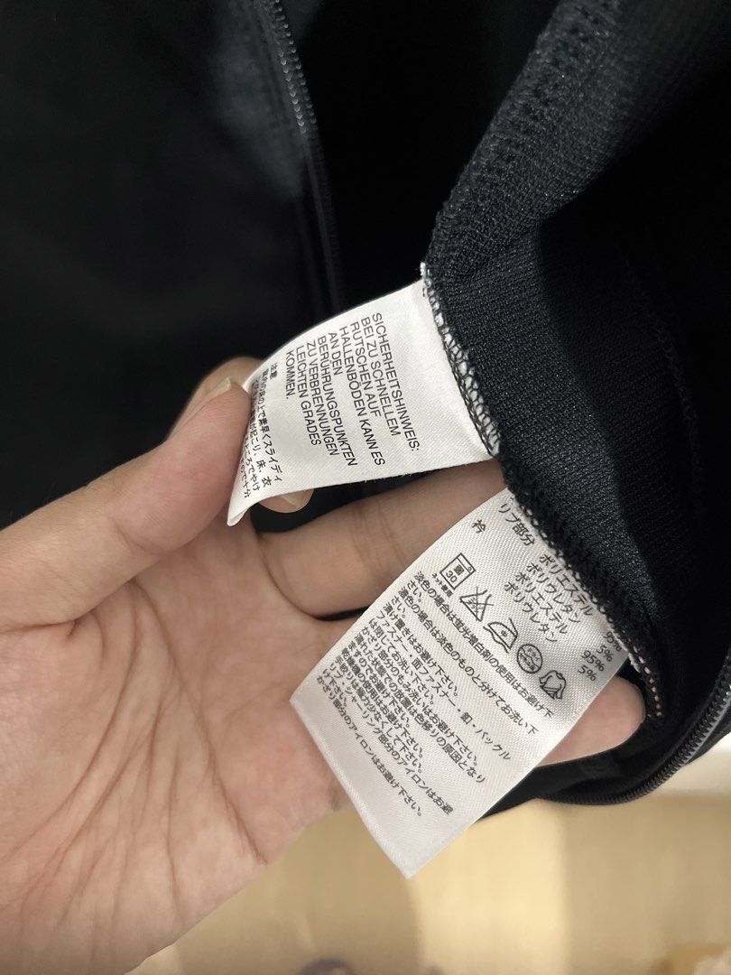 Adidas Neo Black Track Jacket Size M (Category: Coats, Jackets and Outerwear) located in Baguio. Submitted by gbwardrobe (Listing ID 1468332348, Image 3). Description: - Brand: Adidas Neo - Color: Black with coral, white, and grey stripes - Size: Medium (based on neck tag) - Material: Cotton and polyester blend - Features: Full zip closure, ribbed collar, iconic three stripes on sleeves, two side slip pockets - Condition: Clean, minimal signs of 