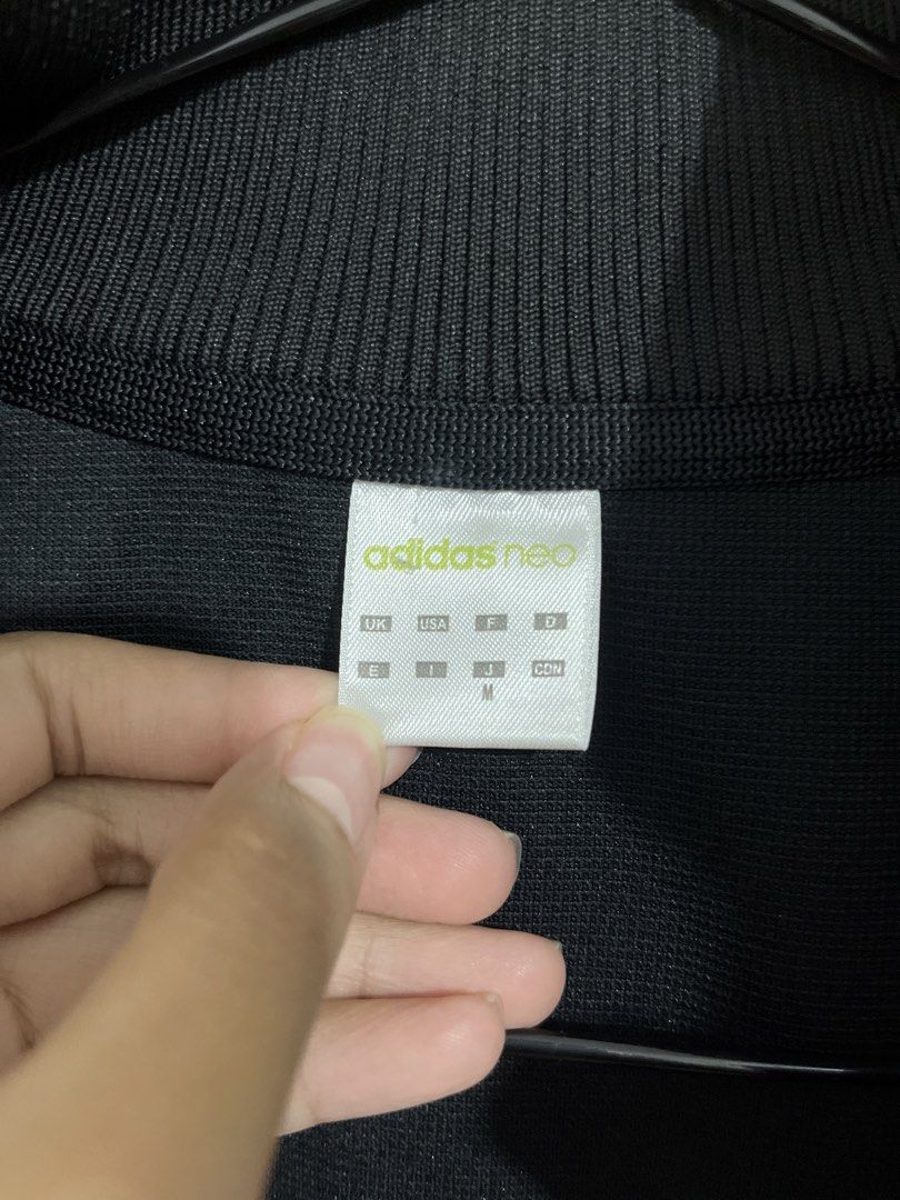 Adidas Neo Black Track Jacket Size M (Category: Coats, Jackets and Outerwear) located in Baguio. Submitted by gbwardrobe (Listing ID 1468332348, Image 2). Description: - Brand: Adidas Neo - Color: Black with coral, white, and grey stripes - Size: Medium (based on neck tag) - Material: Cotton and polyester blend - Features: Full zip closure, ribbed collar, iconic three stripes on sleeves, two side slip pockets - Condition: Clean, minimal signs of 