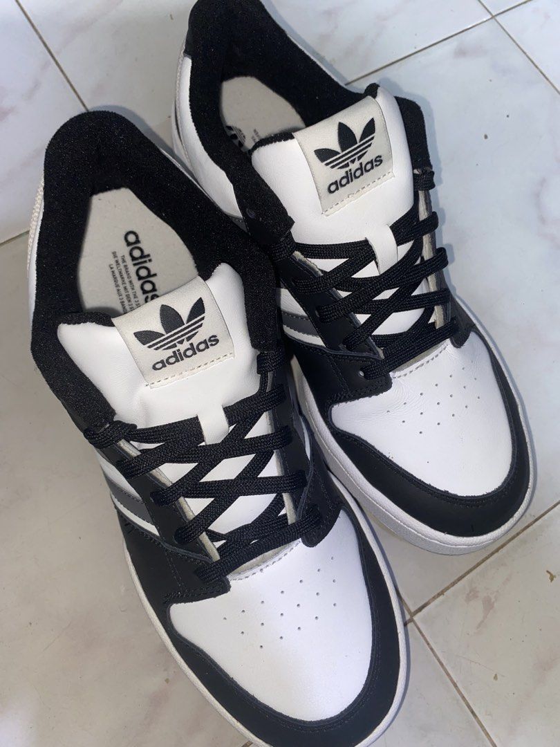 Adidas Postmove Low / Forum Low (Black/White Colorway) (Category: Sneakers) located in Pasig City. Submitted by six_seven67 (Listing ID 1468380053, Image 1). Description: SIZE: US - 10 1/2, UK - 10, FR 44 2/3, JP 285, CHN 275 - Brand: Adidas - Style: Classic low-top sneakers - Colorway: Black and white with grey accent striping - Material: Clean leather upper with perforated toe box - Features: Iconic three stripes, black laces, matching inner li