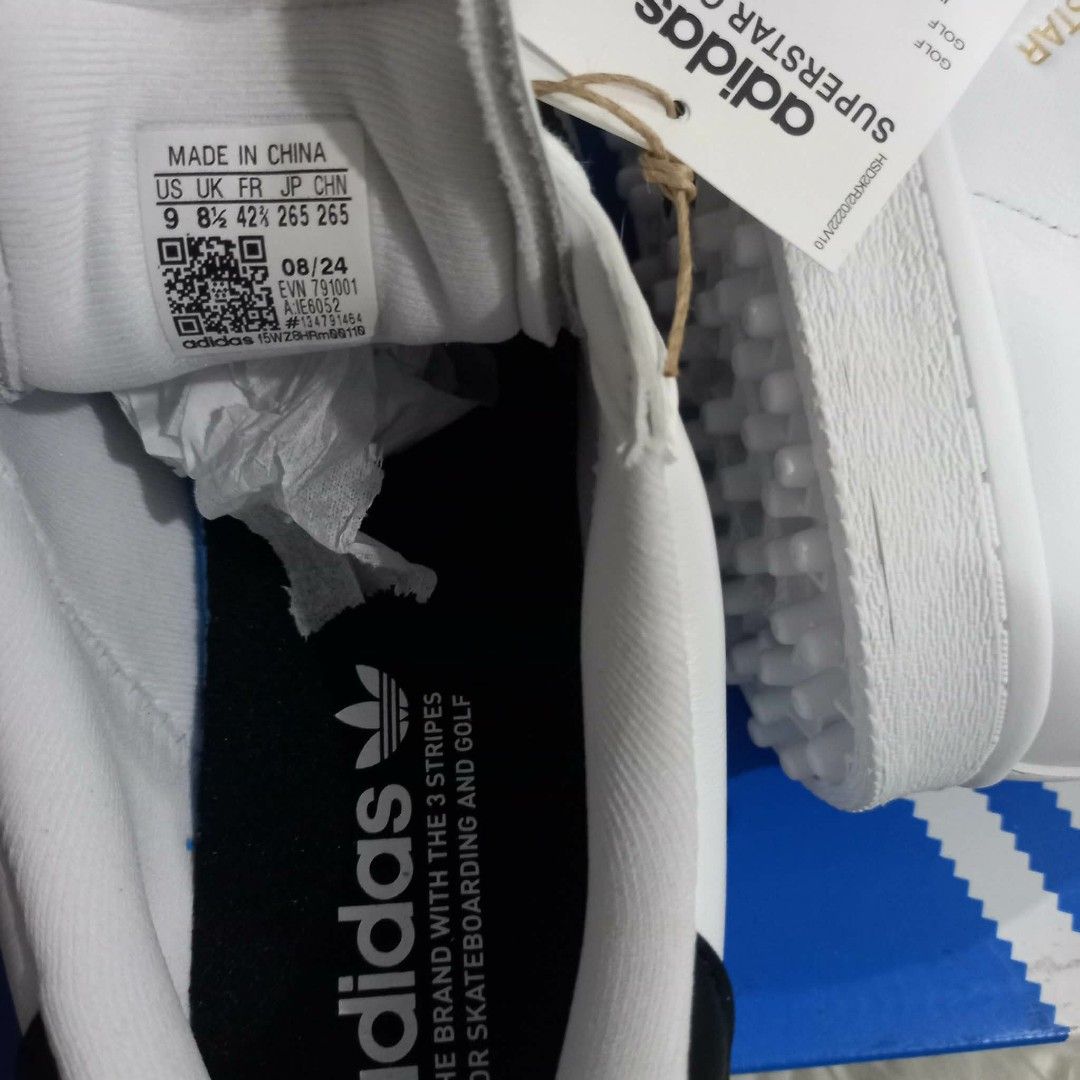 Adidas Superstar Golf Shoes Core Black White (Category: Sneakers) located in Cavite. Submitted by tobias_7795 (Listing ID 1468443063, Image 3). Description: - Brand: Adidas Superstar Golf Shoes - Color: White with Black Stripes - Condition: Brand new with tags attached on laces - Size: US 9 / UK 8.5 / EU 42 2/3 - Design: Classic shell toe with specialized spiked outsoles for maximum grip on the course - Inclusion: Comes with original blue and whi