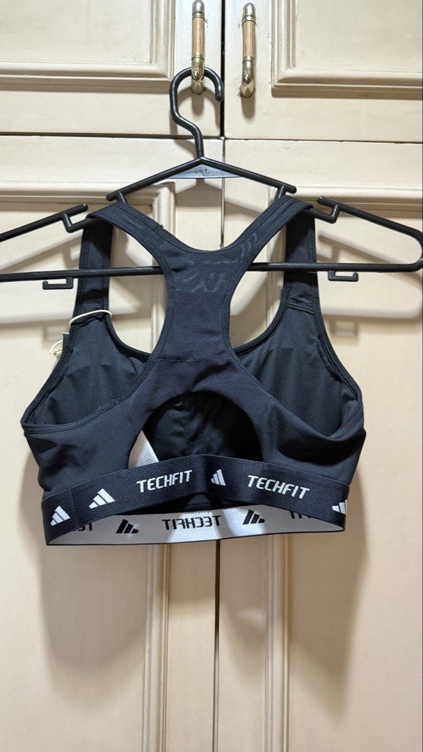 Adidas Techfit Medium Support Sports Bra Black (Category: Activewear) located in Manila. Submitted by christine29467 (Listing ID 1468312469, Image 3). Description: - Brand: Adidas - Model: Techfit Sports Bra - Color: Black with white Adidas logo - Size: Small (C/D) - Support: Medium support design - Features: Racerback, elastic band with techfit branding - Condition: Brand new with original retail tag attached (PHP 1,800). Selling for only P1,300