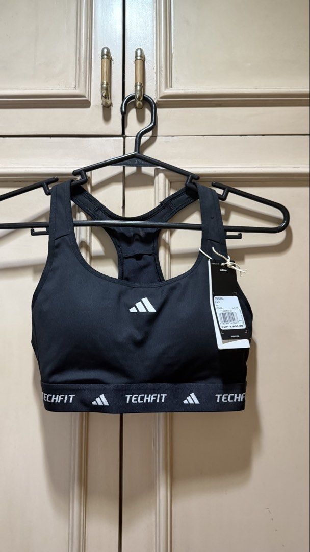 Adidas Techfit Medium Support Sports Bra Black (Category: Activewear) located in Manila. Submitted by christine29467 (Listing ID 1468312469, Image 2). Description: - Brand: Adidas - Model: Techfit Sports Bra - Color: Black with white Adidas logo - Size: Small (C/D) - Support: Medium support design - Features: Racerback, elastic band with techfit branding - Condition: Brand new with original retail tag attached (PHP 1,800). Selling for only P1,300