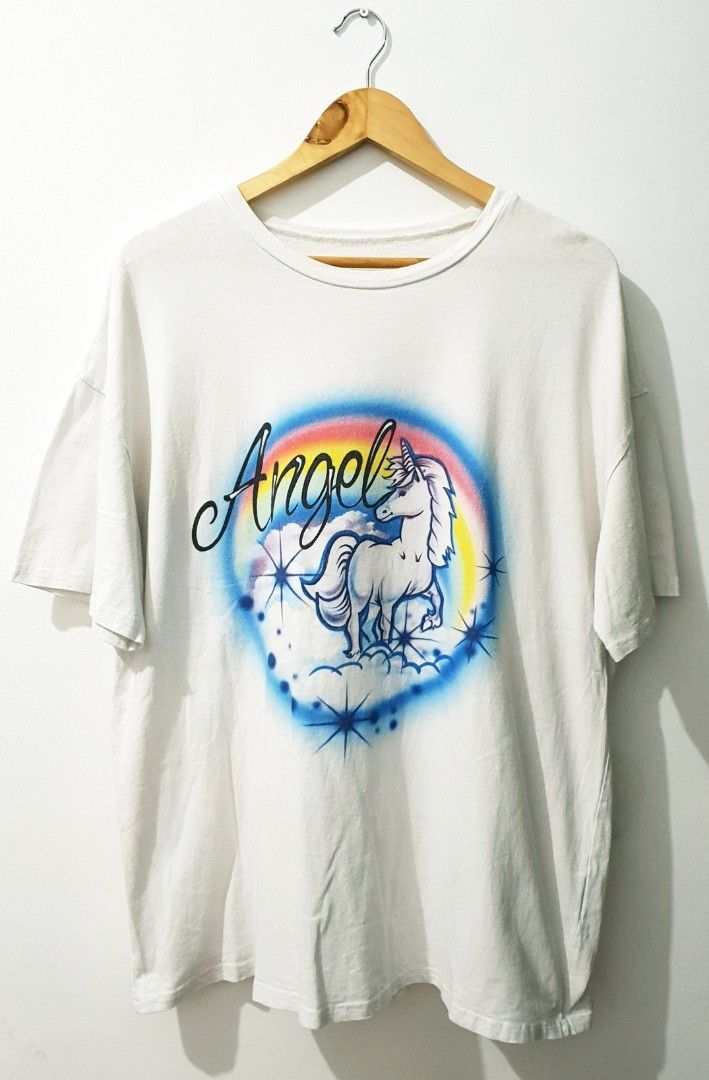 Airbrush Unicorn Rainbow Angel (Category: Tshirts & Polo Shirts ) located in Taguig. Submitted by wethrifting2021 (Listing ID 1468418394, Image 1). Description: Item: Airbrushed Unicorn🔥 Size: Cut tag Width: 23.5 Length: 30 Condition: Excellent Issue: Minimal Deo stain SWIPE MORE DETAILS. DM to purchase 📩.