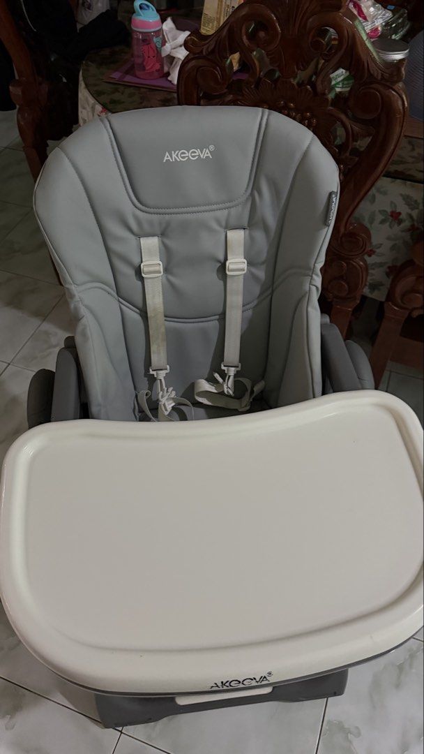 Akeeva Cozzi High Chair (Category: Baby High Chairs) located in Tagaytay City. Submitted by alexaerina (Listing ID 1468298372, Image 1). Description: - Brand/Model: Akeeva Cozzi High Chair - Color: Grey with white tray and grey plastic accents - Height Adjustment: 6 positions for custom feeding levels - Tray: 2-position adjustable white tray - Safety & Comfort: Leatherette seat pad with built-in safety harness - Storage: Sturdy metal frame that f