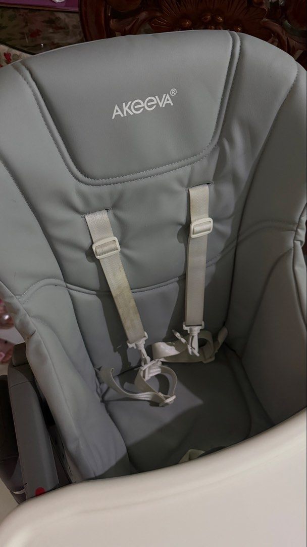 Akeeva Cozzi High Chair (Category: Baby High Chairs) located in Tagaytay City. Submitted by alexaerina (Listing ID 1468298372, Image 3). Description: - Brand/Model: Akeeva Cozzi High Chair - Color: Grey with white tray and grey plastic accents - Height Adjustment: 6 positions for custom feeding levels - Tray: 2-position adjustable white tray - Safety & Comfort: Leatherette seat pad with built-in safety harness - Storage: Sturdy metal frame that f