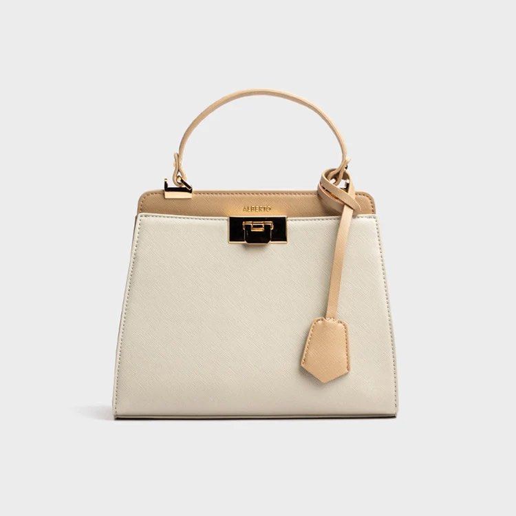 Alberto Cressa Prisma Two-Tone Structured Handbag with Shoulder Strap (Category: Cross-body Bags) located in Dasmarinas. Submitted by phia.aesi (Listing ID 1468325117, Image 1). Description: - Brand: Alberto - Color: Off-white and tan (Neutral, goes with everything) - Material: Structured faux leather with saffiano texture - Hardware: Gold-tone with front clasp closure - Straps: Top handle and adjustable branded shoulder strap - Condition: Like n