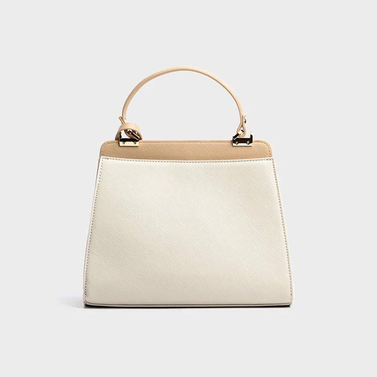 Alberto Cressa Prisma Two-Tone Structured Handbag with Shoulder Strap (Category: Cross-body Bags) located in Dasmarinas. Submitted by phia.aesi (Listing ID 1468325117, Image 2). Description: - Brand: Alberto - Color: Off-white and tan (Neutral, goes with everything) - Material: Structured faux leather with saffiano texture - Hardware: Gold-tone with front clasp closure - Straps: Top handle and adjustable branded shoulder strap - Condition: Like n