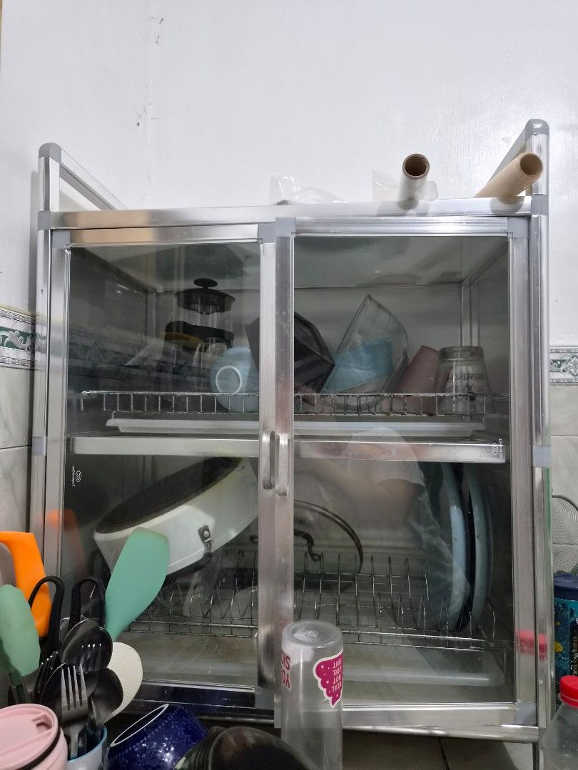 Aluminum double deck kitchen dish drying rack cabinet (Category: Food Organization & Storage) located in Taguig. Submitted by nowinowy (Listing ID 1468491089, Image 1). Description: - Aluminum and glass kitchen cabinet for drying and storing dishes - Two tiers inside with built-in wire racks for plates, bowls, and pot lids - Glass doors to keep your dinnerware dust-free - Sturdy metal frame construction Note: Overall, item is well maintained and 