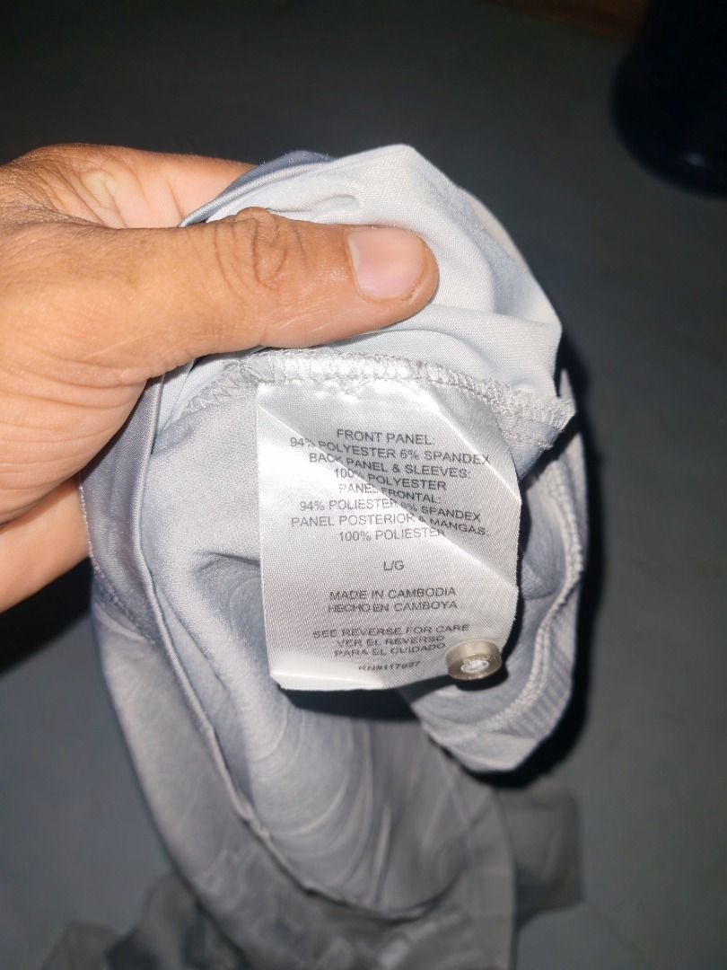 AND1 Grey Polo Shirt (Category: Tshirts & Polo Shirts ) located in Caloocan City. Submitted by silverbird_6c038f (Listing ID 1468410998, Image 2). Description: - Brand: AND1 - Color: Grey - Size: Large - Front Panel: 94% polyester, 6% spandex for flexible comfort - Back & Sleeves: 100% breathable polyester - Design: Classic collar with button placket and subtle graphic print near the bottom hem - Condition: Brand new with tag attached.