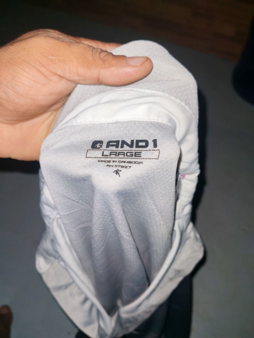 AND1 Grey Polo Shirt (Category: Tshirts & Polo Shirts ) located in Caloocan City. Submitted by silverbird_6c038f (Listing ID 1468410998, Image 3). Description: - Brand: AND1 - Color: Grey - Size: Large - Front Panel: 94% polyester, 6% spandex for flexible comfort - Back & Sleeves: 100% breathable polyester - Design: Classic collar with button placket and subtle graphic print near the bottom hem - Condition: Brand new with tag attached.