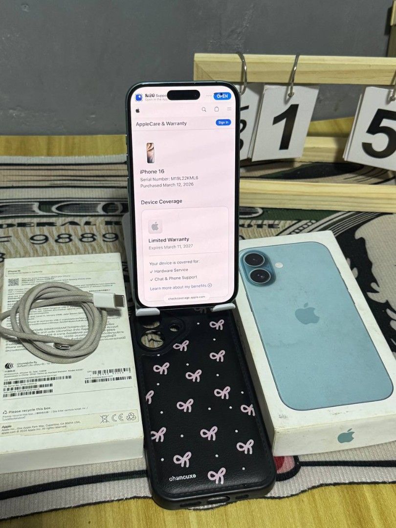 Apple iPhone 16 Teal 128GB with Box and Case (Category: iPhone 16 Series) located in Manila. Submitted by warmhorse.7002aa (Listing ID 1468325432, Image 2). Description: - Model: Apple iPhone 16 - Color: Teal - Storage: 128GB - Battery Health: 95% - Warranty: AppleCare limited warranty active until March 2027 - Inclusions: Original box, charging cable, and free black phone case with pink bow patterns - Condition: Excellent, well-taken care of.
