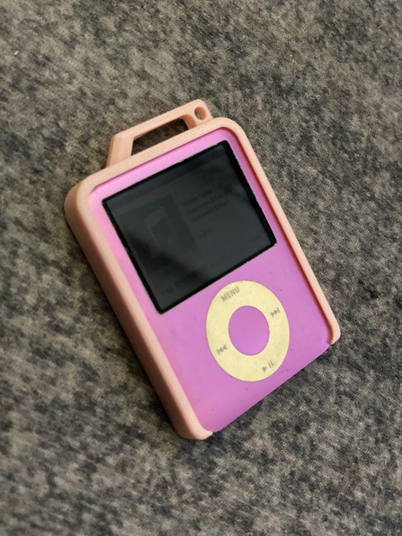 Apple iPod Nano 3rd Gen 8GB Pink (Category: Portable Music Players) located in Dasmarinas. Submitted by bbgaminghub (Listing ID 1468319685, Image 2). Description: - Model: iPod Nano 3rd Generation (Square screen with click wheel) - Capacity: 8GB - Color: Pink - Condition: Fully functional, good battery life, clear screen, with normal scuffs on the chrome back from use - Inclusions: High Quality 3D print protective case with a top loop.